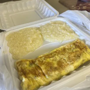 an omelet and chips in a styrofoam container