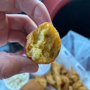 a person holding a half eaten food item