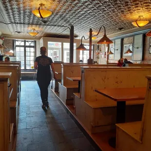 Interior with booths and stamped tin ceiling.