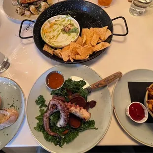 Chips &amp; Guac on top, grilled bread on the left, Spanish Octopus in the middle and a side of fries on the right.