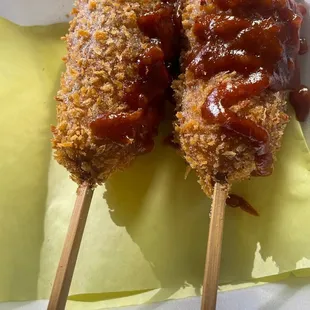 two skewers of food on a plate