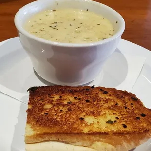 Cup of clam chowder comes with bread. All you can eat crackers on table.