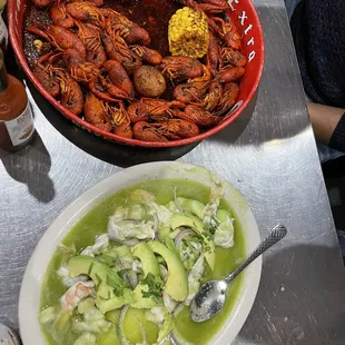 a bowl of crawfish and a bowl of avocado soup