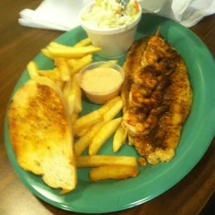 a plate of food with fries and coleslaw