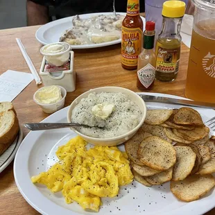 Eggs, grits, potatoes and biscuits in gravy in rear.