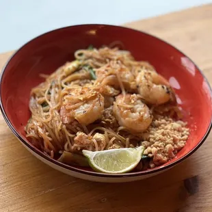 a bowl of food on a wooden table