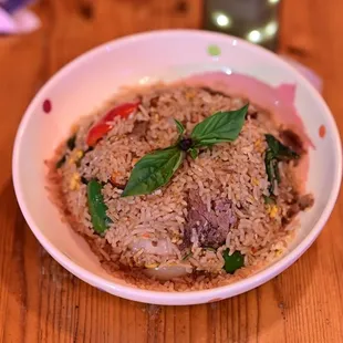 a bowl of food on a wooden table