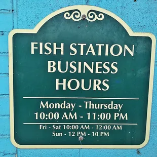 a sign for the fish station hours
