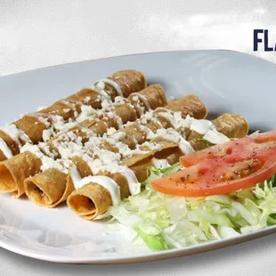 a plate of fish tacos with tomatoes and lettuce