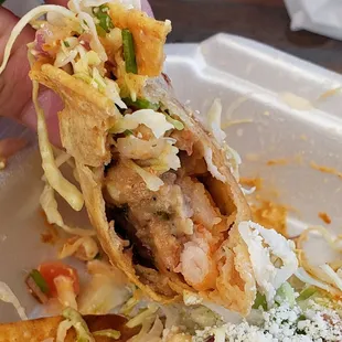 Inner workings of shrimp taco dorado i believe it had beans in it too.