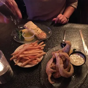 a person sitting at a table with a plate of food