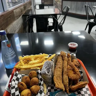 Fried catfish Fish and Shrimp Combo Meal with Cornbread and Hush Puppies.