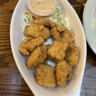 a plate of fried fish and coleslaw