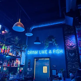 a neon sign above the bar