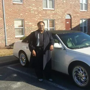 a man standing next to a car