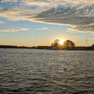 the sun setting over the water