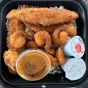 a tray of fried fish and rice