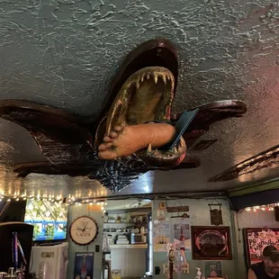 a fish head hanging from the ceiling