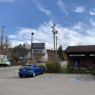 a blue car in a parking lot