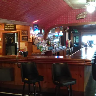 The bar, with vintage red wallpaper.