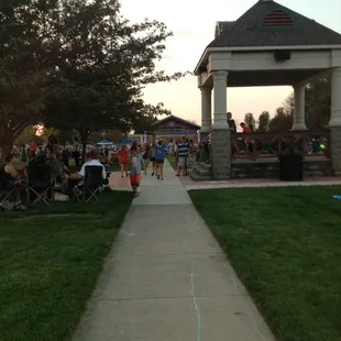 a crowd of people sitting in lawn chairs