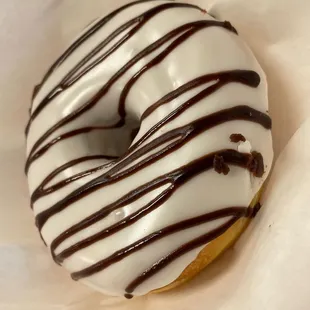 a glazed donut with chocolate drizzle