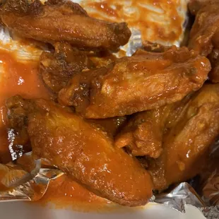 a plate of chicken wings and sauce