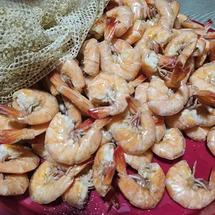 a pile of shrimp on a red plate