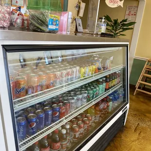 a refrigerated case of sodas
