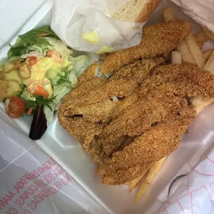 a sandwich and salad in a styrofoam container