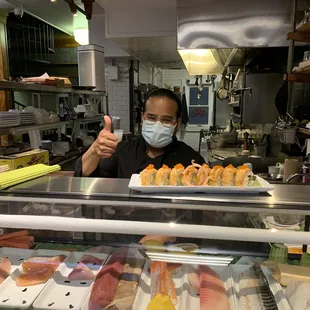 Chef and owner handing over the Firecracker roll