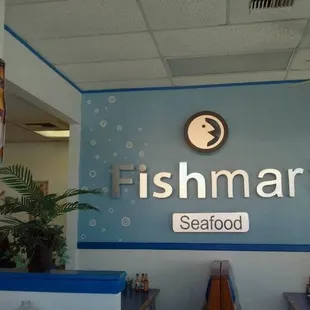 a restaurant with a fish sign on the wall