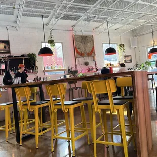 a row of yellow bar stools