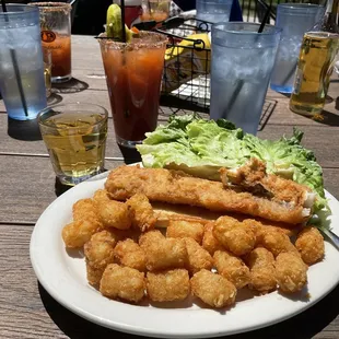 a plate of fried fish and lettuce