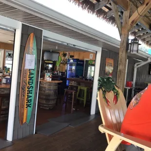 a man sitting at a table with a surfboard