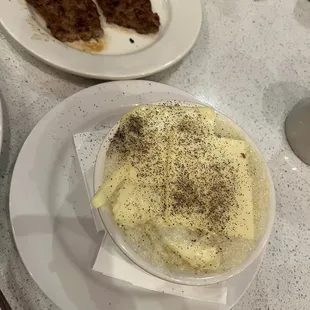 a bowl of mashed potatoes and meat