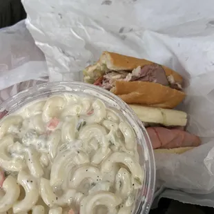 a bowl of macaroni salad and a sandwich