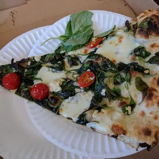 Spinach, feta, garlic, tomato. Fresh basil garnish