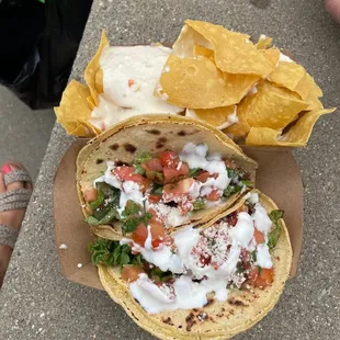 a hand holding a tortilla