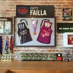 Coach Patty's CrossFit Games jerseys and other member's awards.