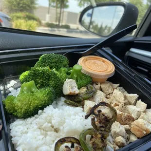 Grilled chicken plate with white rice and broccoli.