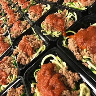 several trays of meat and zucchini