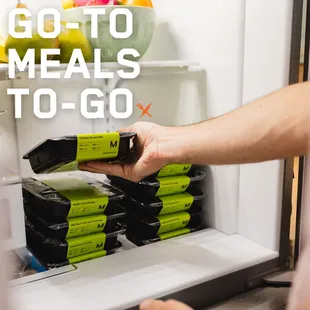 a person opening a refrigerator