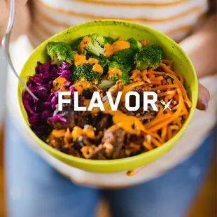 a woman holding a bowl of food