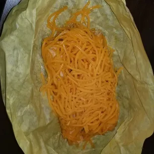 3 taquitos wrapped in paper with raw cheese, I had to place it in the microwave just to melt the cheese