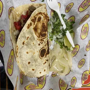 a tortilla with onions and salsa