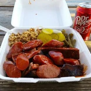 3-meat combo, pork ribs, beef brisket and sausage with dirty rice and green beans.