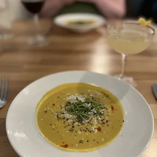 a bowl of soup and a glass of wine