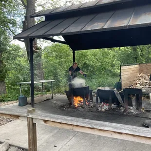 Picture of cook dropping the cod into the boiling caldron.