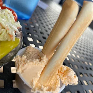 a bowl of coleslaw and a dip